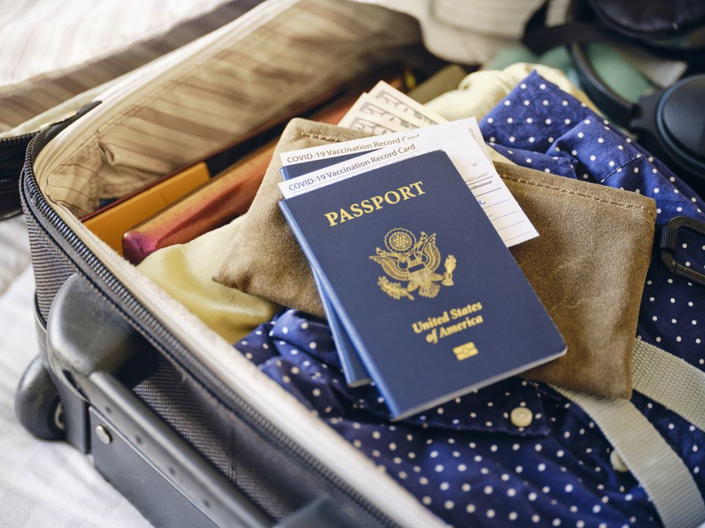 Suitcase and Passport travel documents - Blue Ribbon Travel